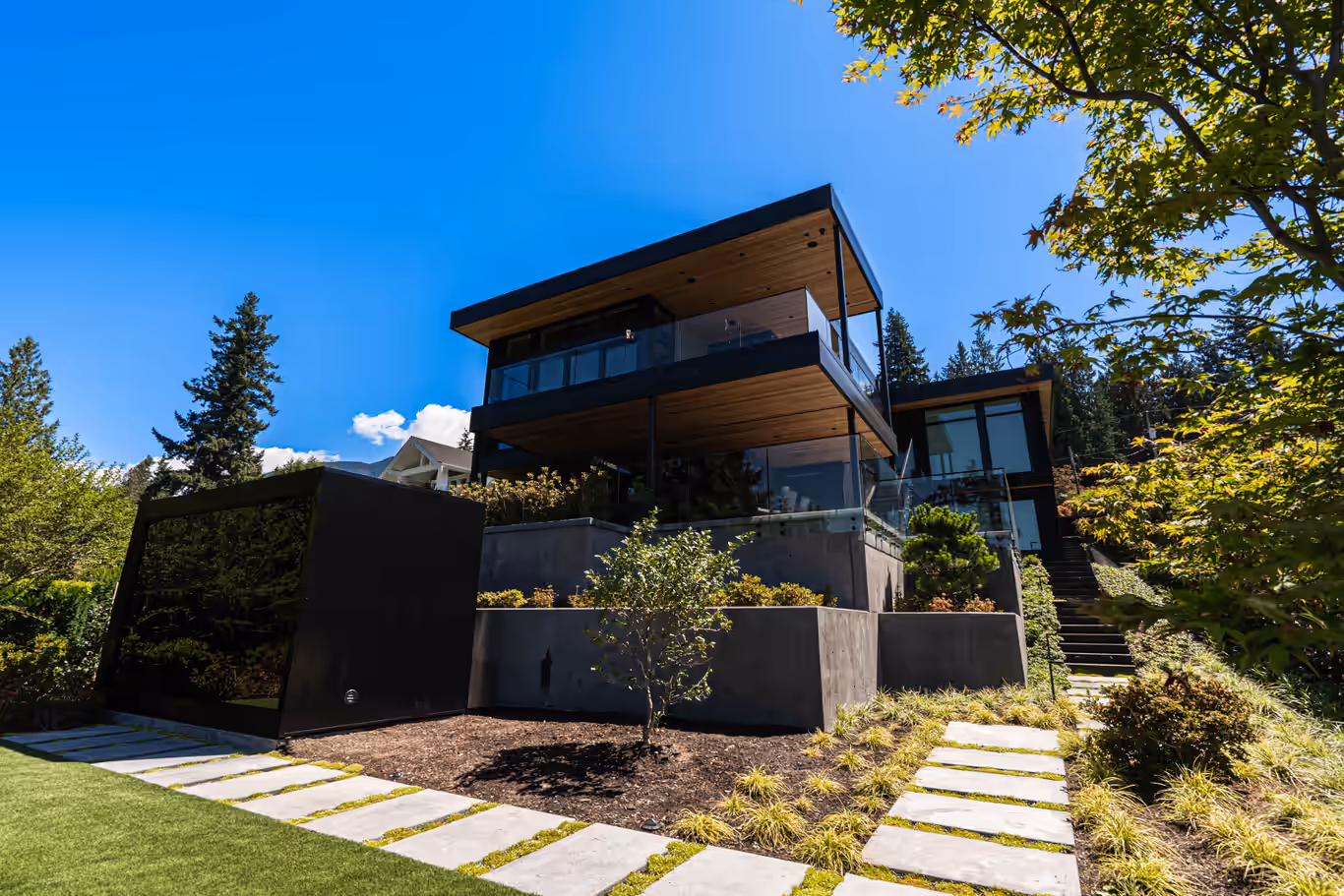 Contemporary dark-clad home on a landscaped Gleneagles hillside in West Vancouver, captured for CityScape Electrical by Perseus Creative Studio.
