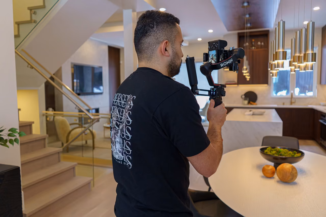 Real estate videographer recording a cinematic walkthrough of a Vancouver property