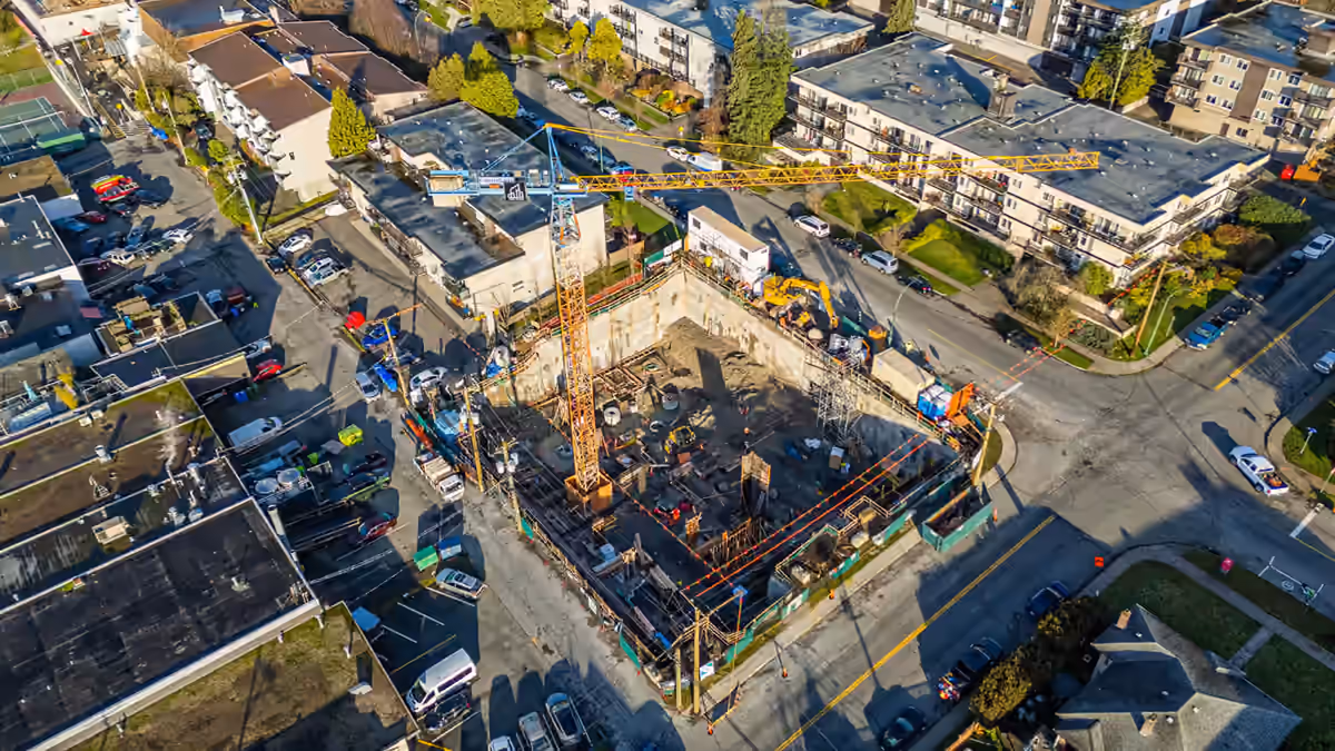 Aerial of an active Vancouver-area construction site with a piling rig during a contractor video production.