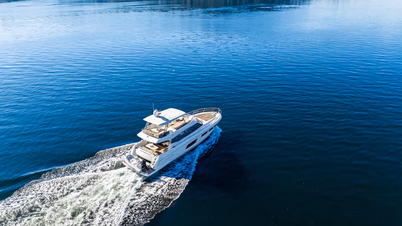 Aerial view of Ignition Marine’s 2016 Prestige 550 Flybridge yacht under way on open water, shot by Perseus Creative Studio.