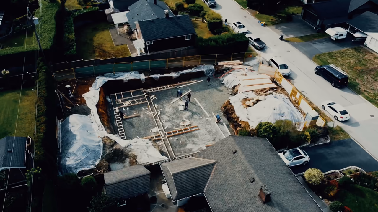 Aerial of the excavated foundation and demolition site at Vela Homes’ 4476 Parliament Crescent project in North Vancouver, documented by Perseus Creative Studio.