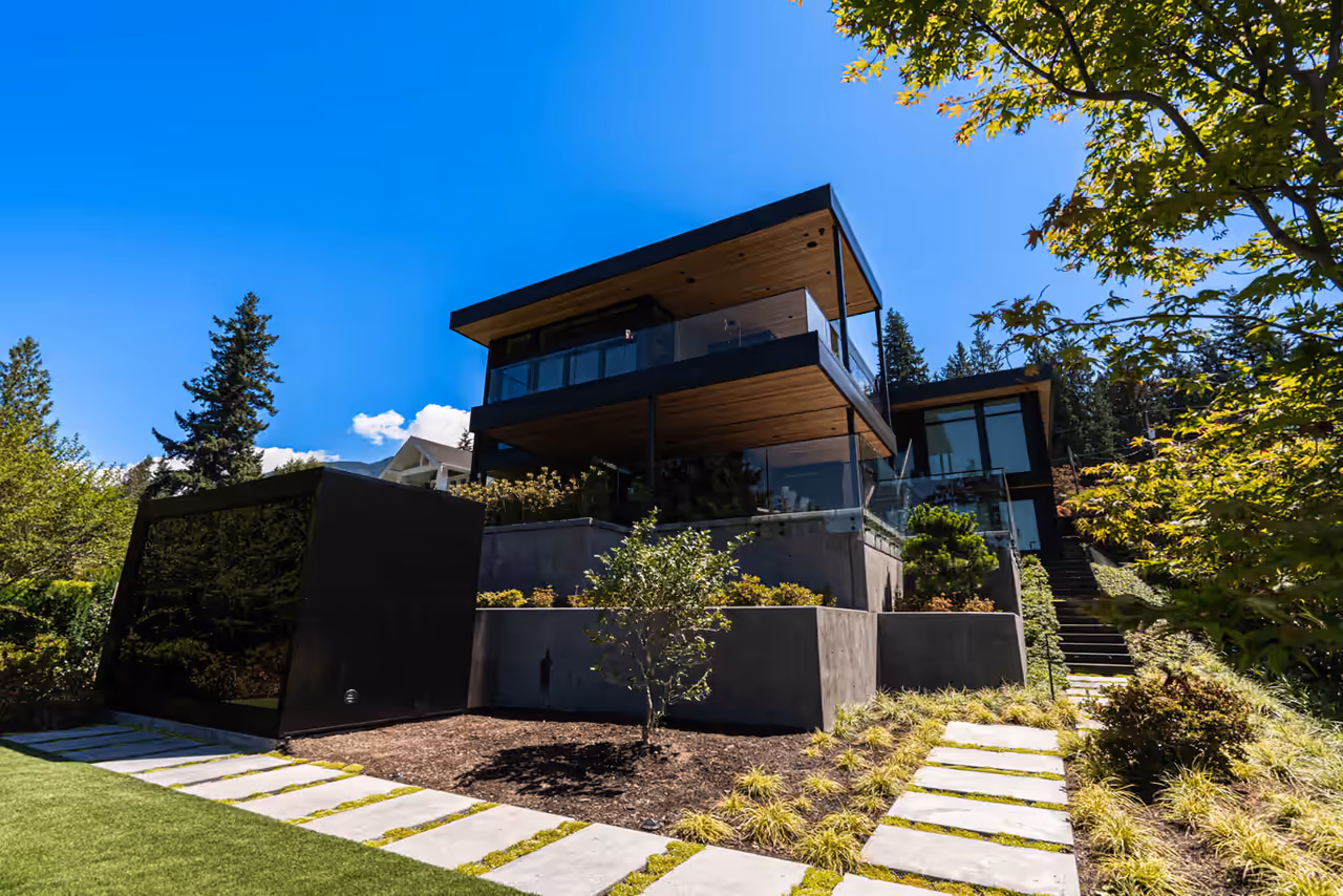 Contemporary dark-clad home on a landscaped Gleneagles hillside in West Vancouver, captured for CityScape Electrical by Perseus Creative Studio.