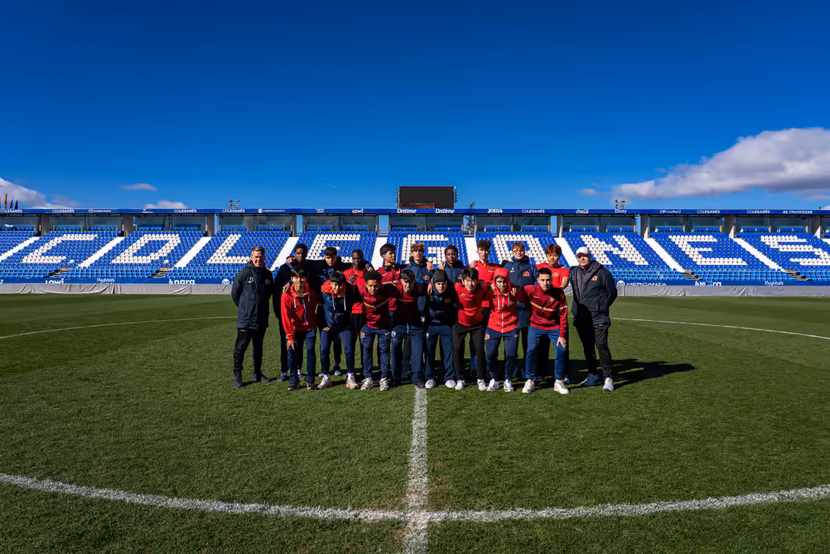 Match Tour 11 squad posing on the pitch during the Buckswood Madrid trip, documented by Perseus Creative Studio.