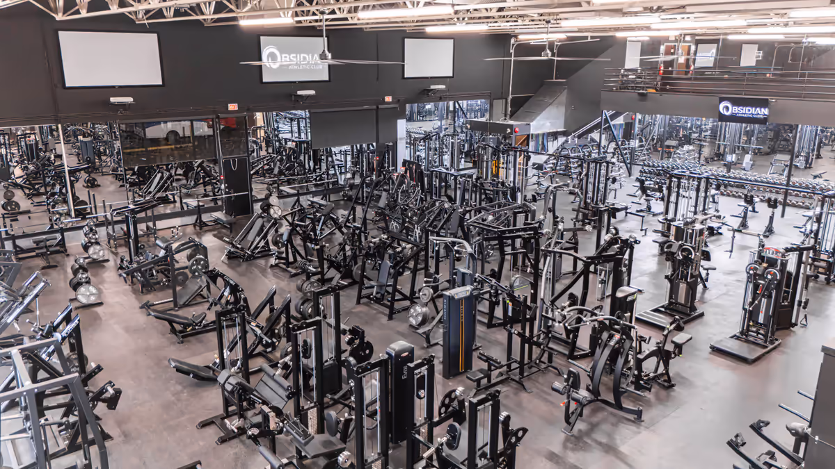 Wide interior of Obsidian Athletic Club’s North Vancouver gym floor packed with strength equipment, photographed by Perseus Creative Studio.