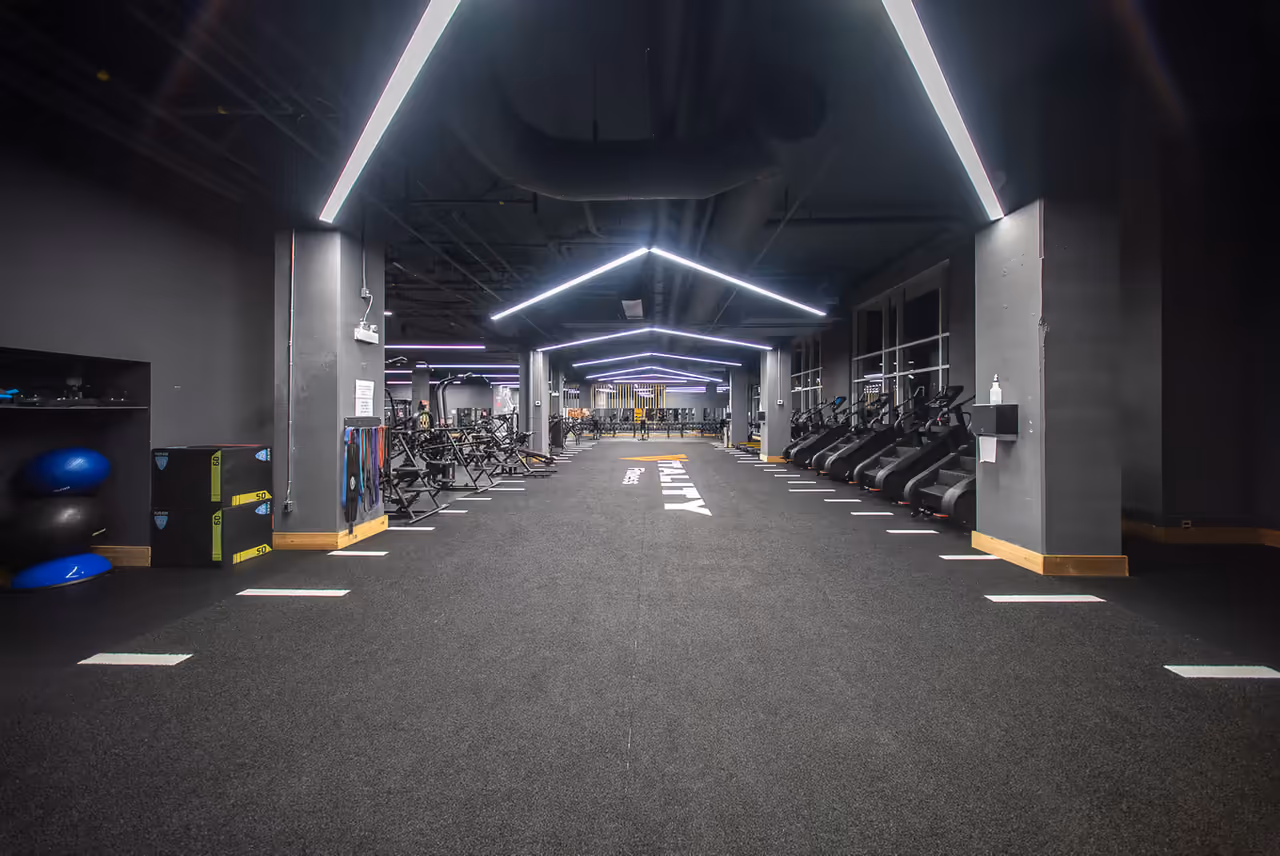 Modern cardio and training floor at Vitality Fitness with lit walkways and rows of equipment, filmed by Perseus Creative Studio.