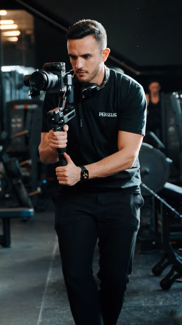 Perseus Creative Studio videographer operating a gimbal-stabilized cinema camera while filming branded video content on location in Vancouver.
